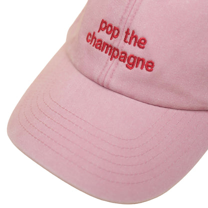 Dusky pink Vintage Cap mit roter Stickerei „pop the champagne“ nah